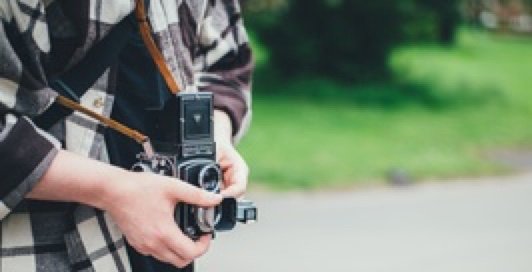 Person Taking a Photograph with a Vintage Camera